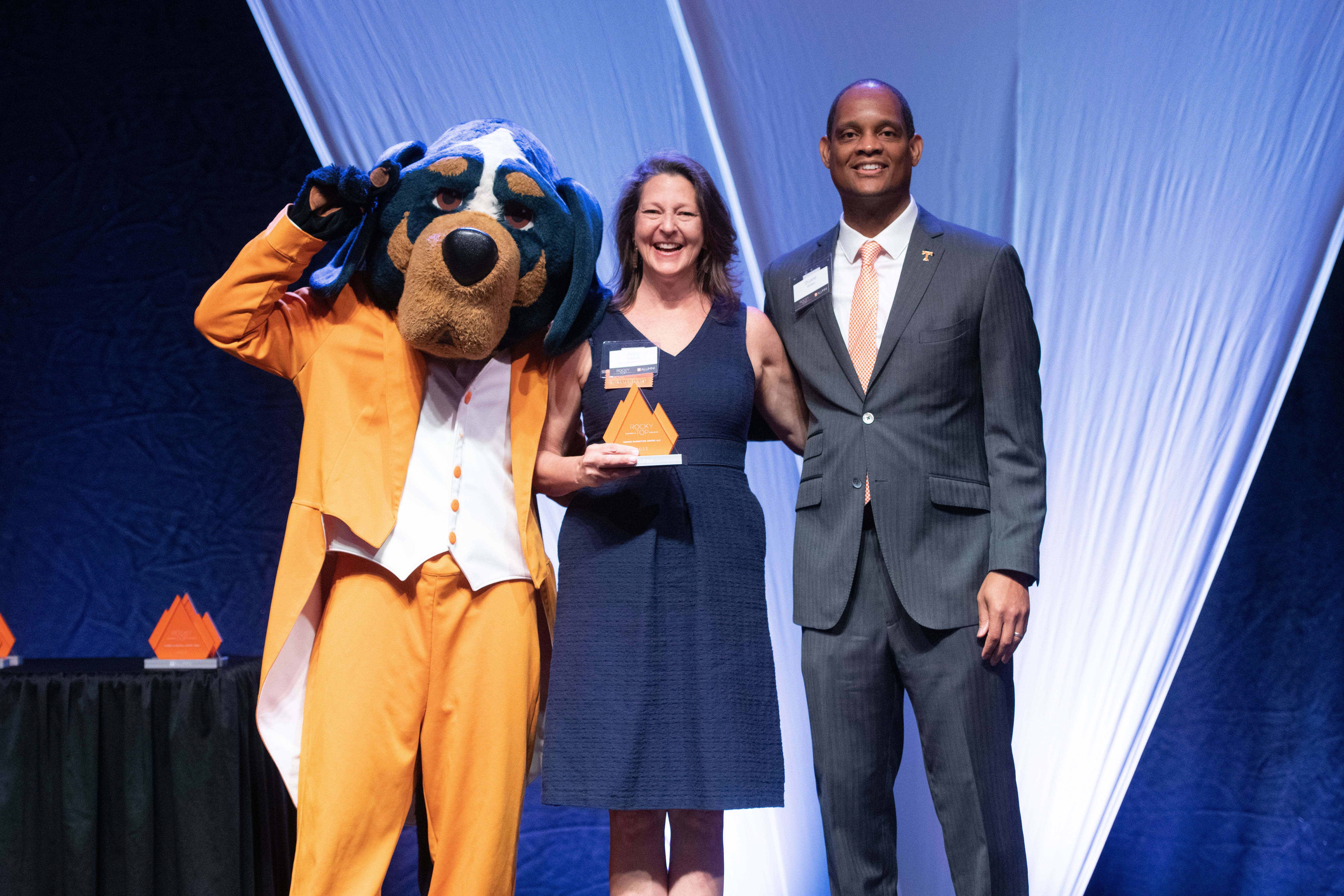 Holly accepting award from UTK and Smokey Outdoor Furniture Plus received an award for being the fastest growing alumni led business in 2023.